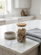 Jar of dog treats on a marble countertop in a kitchen